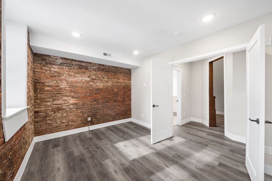 1732 n 22nd st - renovated church apartment for rent philadelphia - master bedroom exposed brick